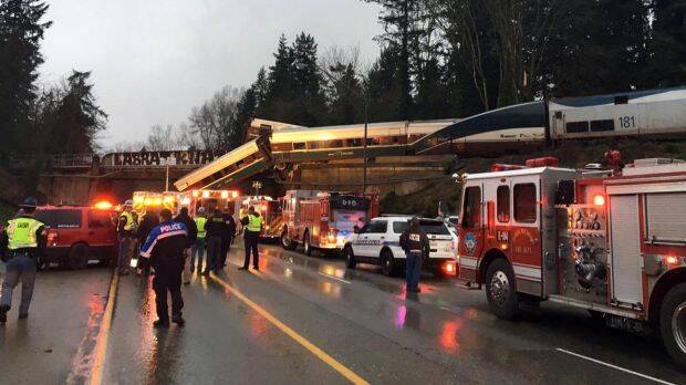 Emergency services at the scene after an Amtrak train derailed south of Seattle. Photo: AP