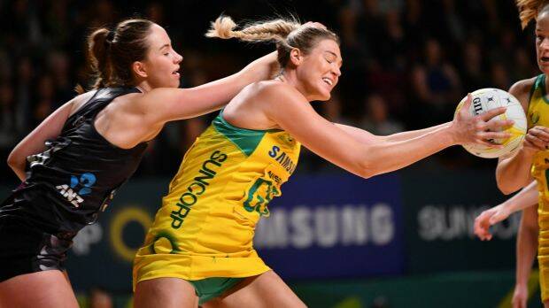 Caitlin Bassett of Australia and Kelly Jury of New Zealand fight for the ball. 