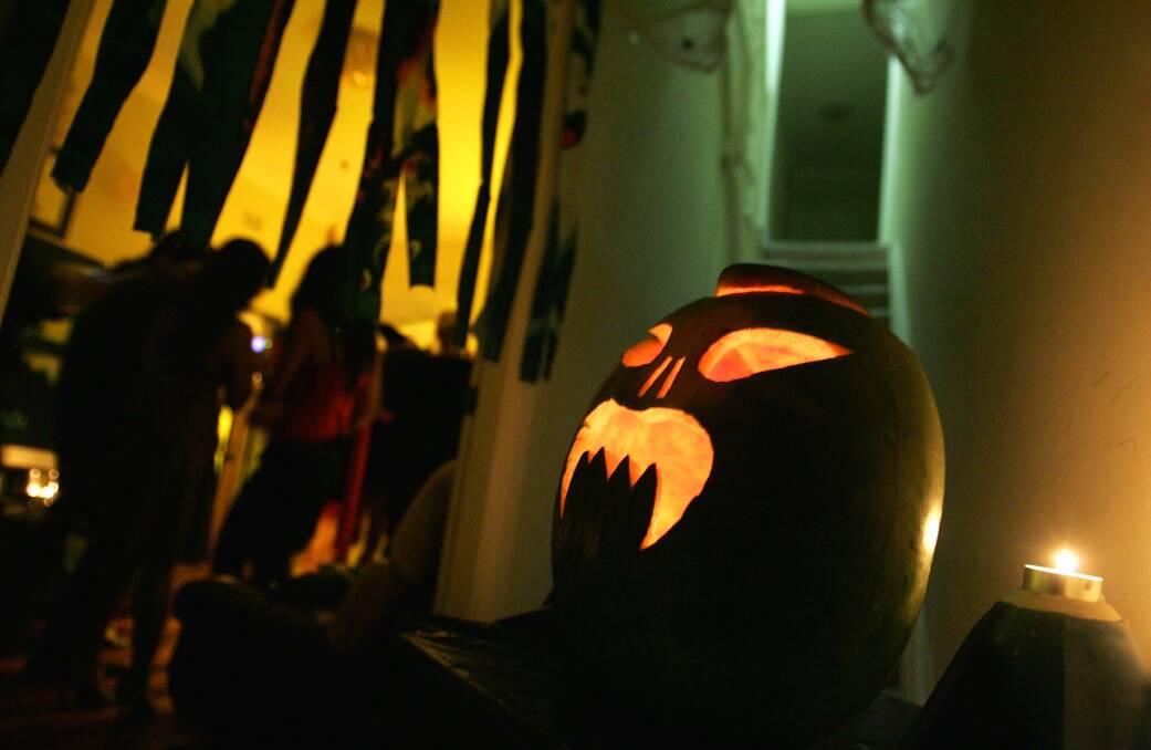 A pumpkin is seen alight at a Halloween house party in Sydney. Photo by Sergio Dionisio/Getty Images
