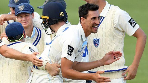 NSW's Mitchell Starc celebrates with teammates after dismissing David Moody on Tuesday. Photo: AAP