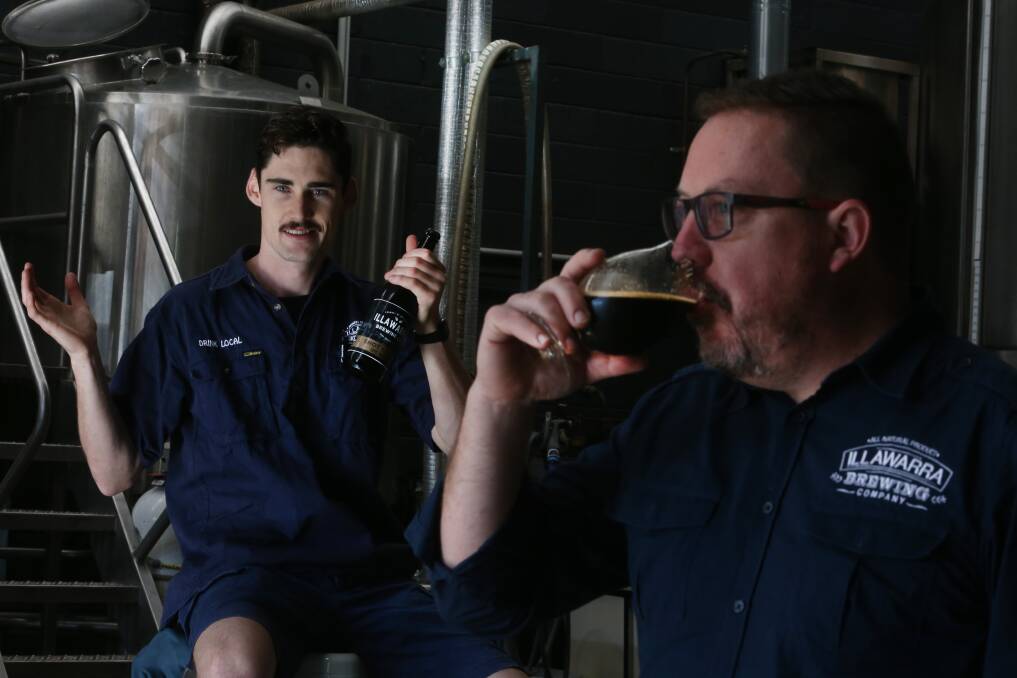 Illawarra Brewing Company boss David McGrath enjoys the beer that brewer Tim Howard (left) isn't able to drink. Picture: Robert Peet