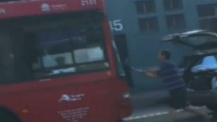 The moment an enraged driver took to the bus with a shovel. Photo: Supplied