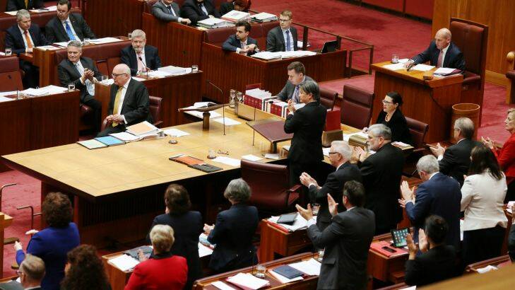 The Opposition praise Senator Brandis after he repudiated Senator Pauline Hanson for wearing a burqa during question time at Parliament House in Canberra on Thursday 17 August 2017. Fedpol. Photo: Andrew Meares 