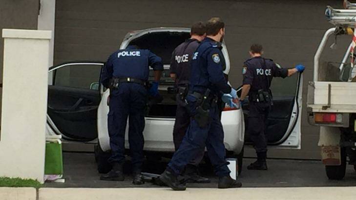 Police search a car during a raid on a house in Lockwood Street, Merrylands, in Sydney's west on Wednesday. Photo: Peter Rae