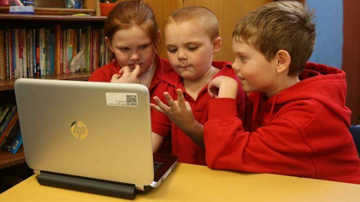Maddie, year 4, Ben, year 1 and Lewis, year 4, from Darlington Public School beta testing the computer maths games the year 4 students had developed to teach younger children. Photo: Louise Kennerley
