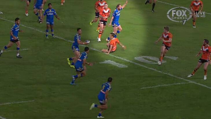 Controversial incident: Tigers halfback Luke Brooks hits the deck in the lead-up to Will Hopoate's disallowed try.