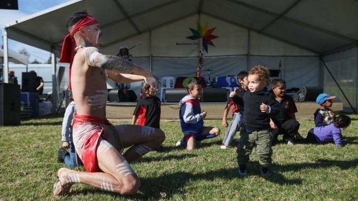 SYDNEY, AUSTRALIA - JULY 04:  Indigenous Dancer Darren Compton with children at NAIDOC Family Fun Day. Photo: Fiona Morris