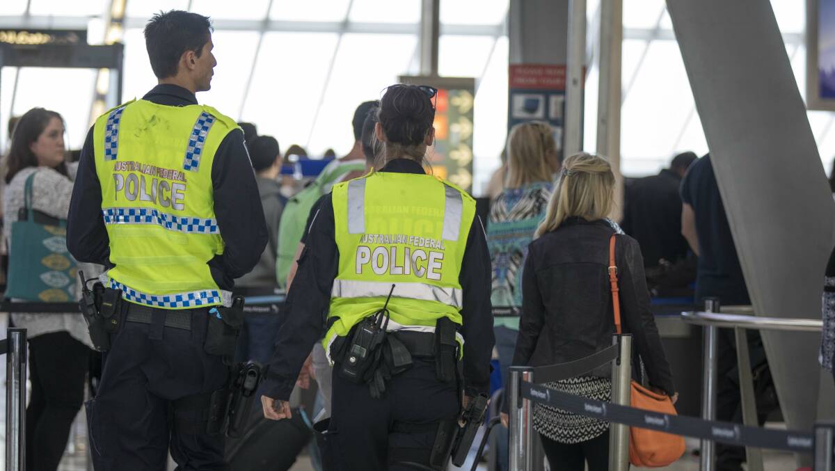 Increased security: Police on patrol at Sydney Domestic Airport on Sunday, after an alleged terrorism threat was revealed. Picture: Michele Mossop