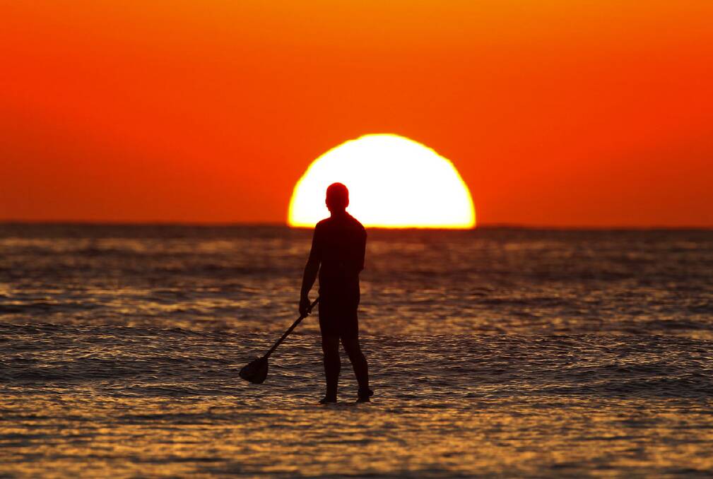 A stand up paddle boarder makes the most of the last days of summer. Photo John Veage