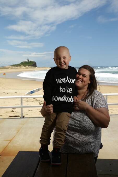 Empathy: Naomi Allen with her four-year-old son Braxton at Nobbys beach. Ms Allen will shave her head to help ease her son's pain. Picture: Jonathan Carroll 