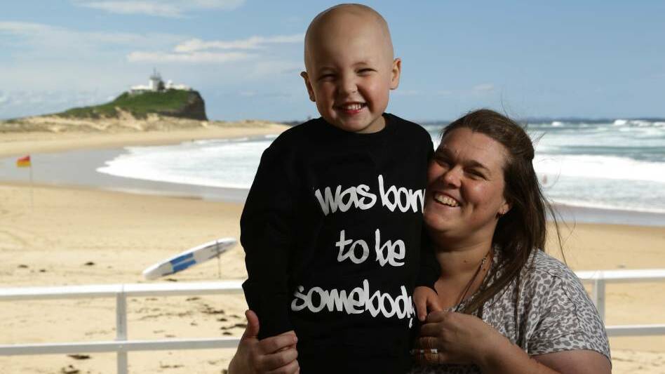 Empathy: Naomi Allen with her four-year-old son Braxton at Nobbys Beach. Ms Allen will shave her head to help ease her son's pain. Pictures: Jonathan Carroll