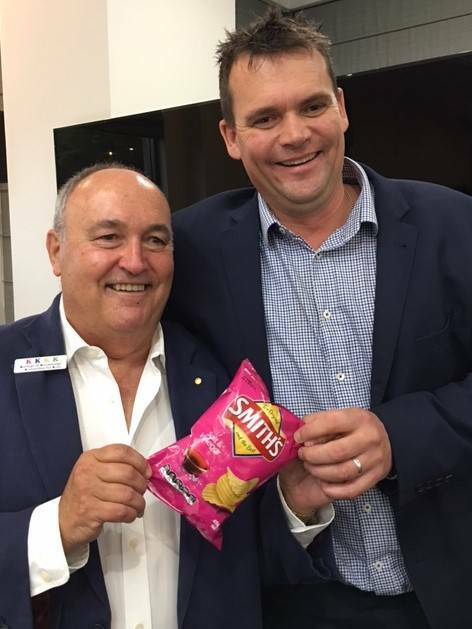 4K president Tony Springett and auctioneer Nicko Johnson hold the $3600 packet of chips. Photo: Supplied.