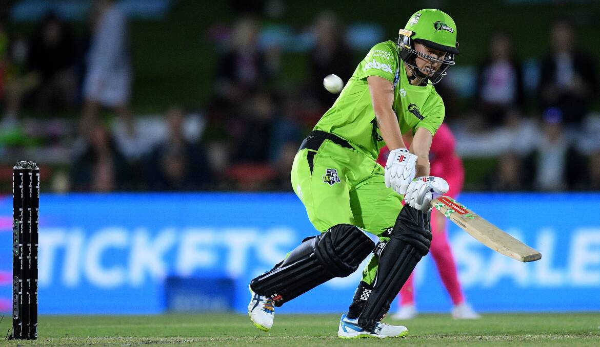 CONFIDENCE IS HIGH: Phoebe Litchfield scoops her ninth deliver to the vacant fine leg boundary during a stunning debut. Photo: SYDNEY THUNDER