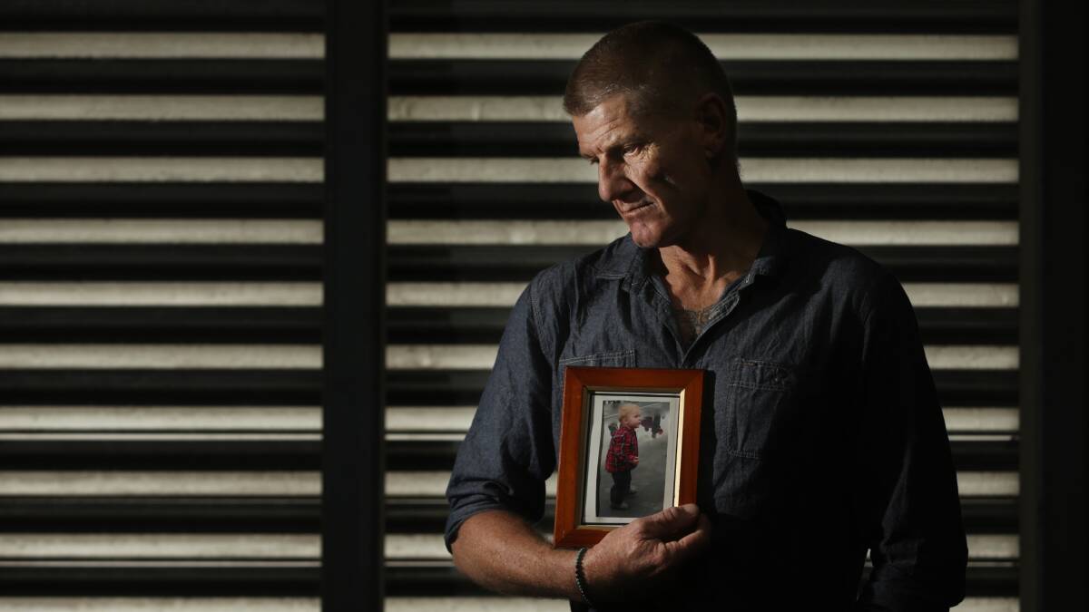TRAGEDY: Rodney Rhodes holds a picture frame of his son Jake. A coronial inquest examined the circumstances surrounding the toddler's death last week. Picture: Simone De Peak