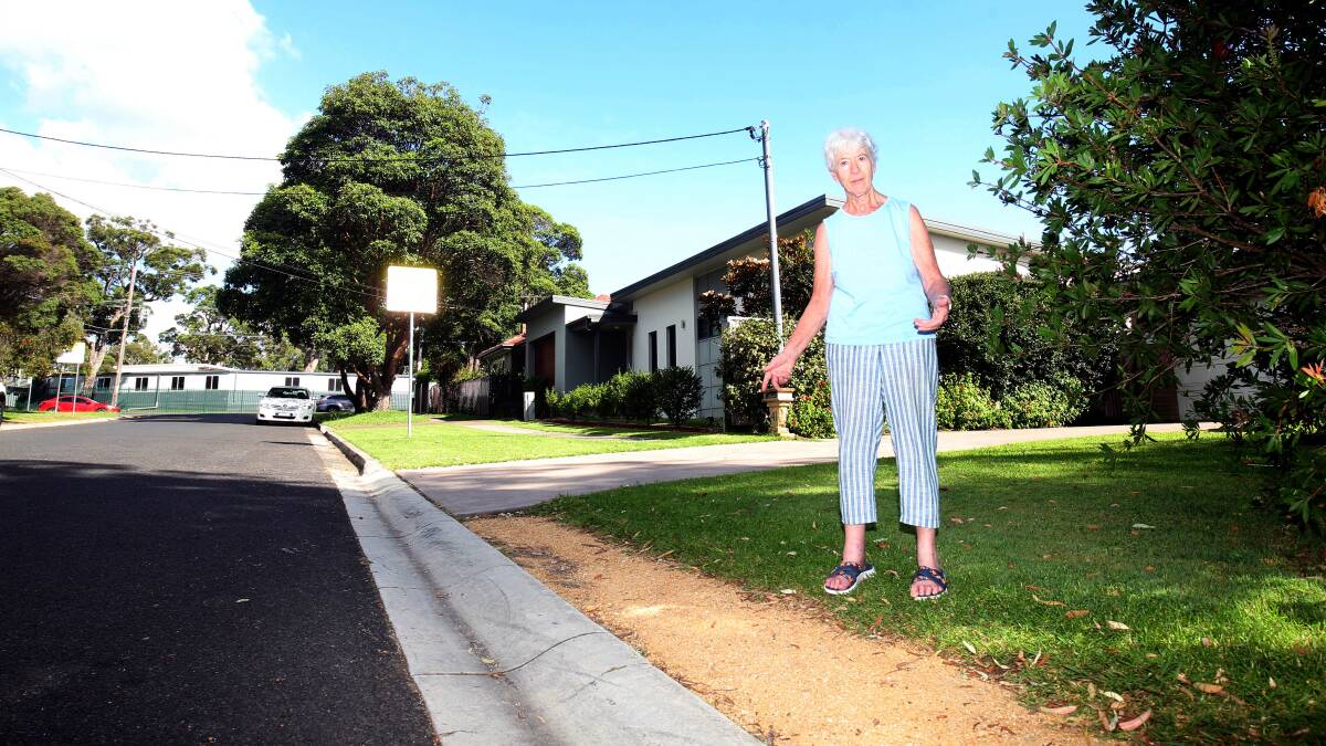 Freda Surgenor inspects the strip in front of her North Caringbah home where gravel has been placed in preparation for a concrete strip to be laid. Picture by Chris Lane