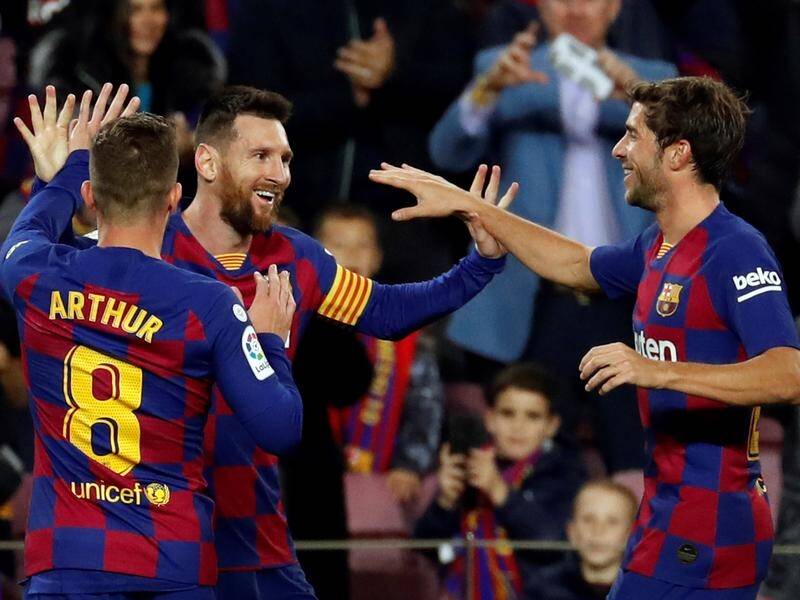 Lionel Messi (c) scored Barcelona's first three goals in their league win over Celta Vigo.