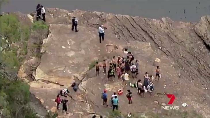 Police and bystanders at Mermaid Pools in Tahmoor on Friday afternoon. Photo: Seven News