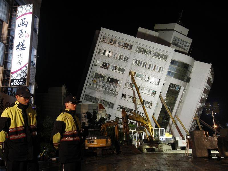 Props have been used to stabilise a collapsed building in Hualien as rescuers search for survivors.