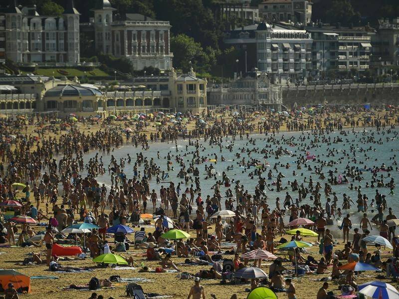 People have crowded onto La Concha beach in the Basque city of San Sebastian in Spain to cool down.