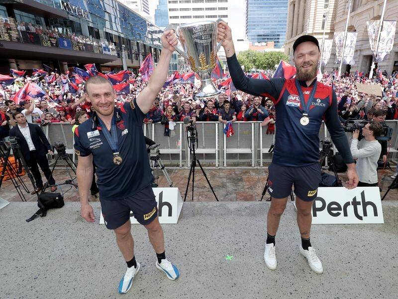 Melbourne coach Simon Goodwin and captain Max Gawn show off the AFL premiership cup in Perth.