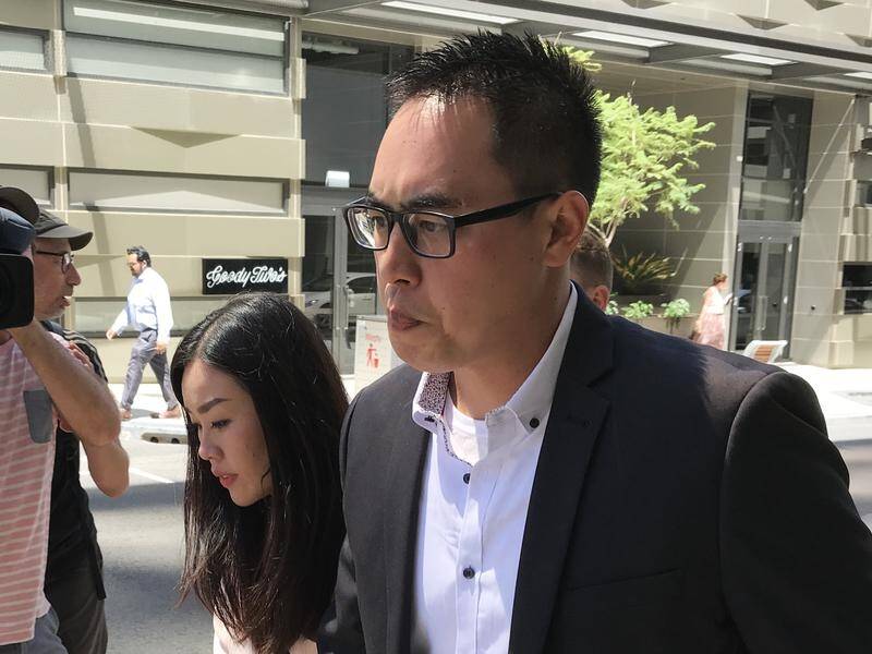 Andrew Doan (right) and fiance Wendy Wang leave the District Court after his acquittal.