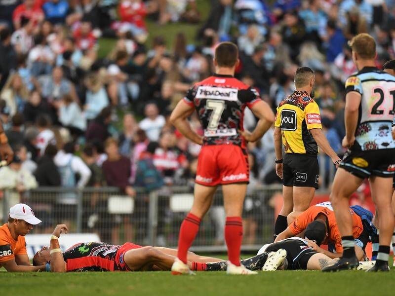 Tyson Frizell (left) receives medical attention after his collision with Shark Joshua Dugan.
