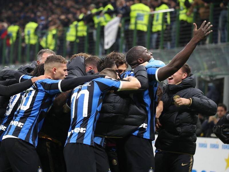 Inter Milan players celebrate their winning goal against Hellas Verona at the San Siro.