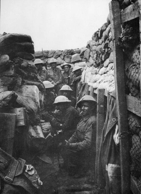 THE WAIT: Men of the 53rd Battalion AIF wait to don their equipment for the attack at Fromelles on July 19, 1916. PHOTO: AWM 03042 